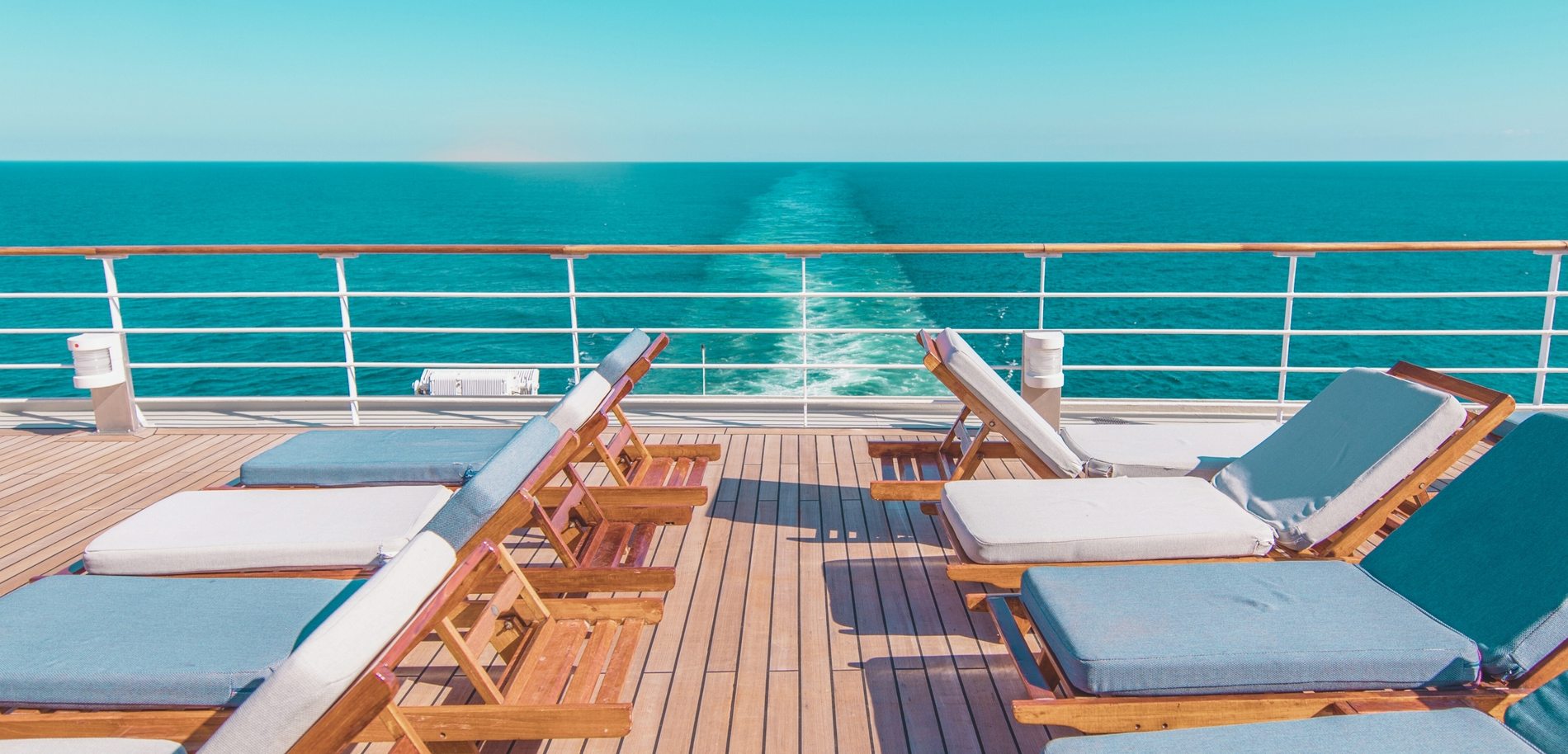 Sun loungers on a cruise ship deck overlooking the open sea